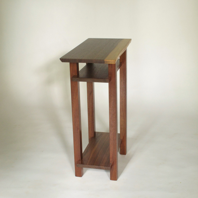 a narrow table with live edge table top. Handmade from solid walnut, this small end table is great for tight spaces.  The live edge table top is unique.
